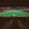 Foto tirada da arquibancada de um estádio de futebol, mostrando o campo um pouco distante